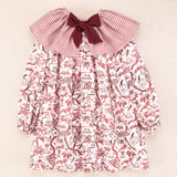 Vestido infantil de manga larga con cuello bebé de cuadros y estampado floral en burdeos, colección Cocote x Charanga
