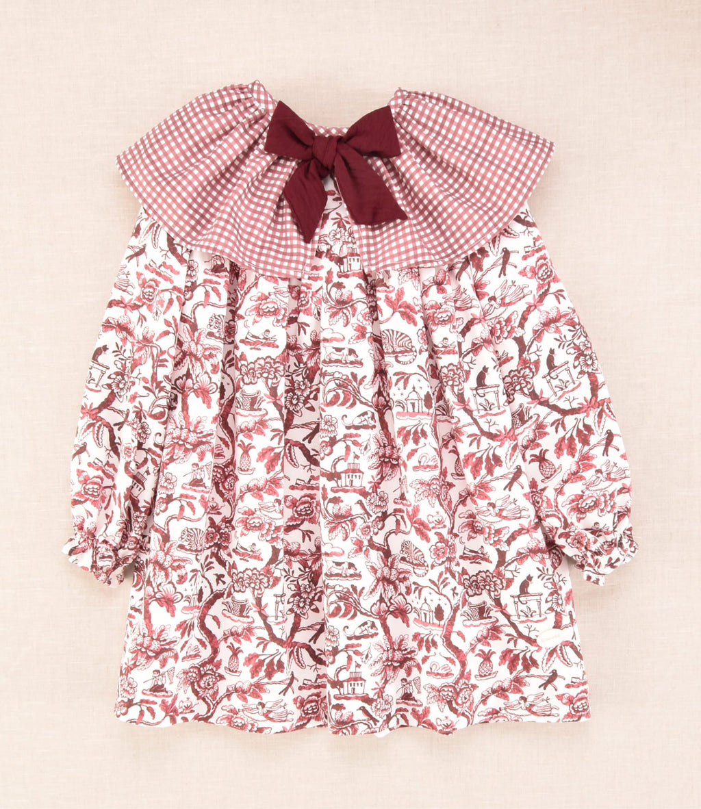 Vestido infantil de manga larga con cuello bebé de cuadros y estampado floral en burdeos, colección Cocote x Charanga