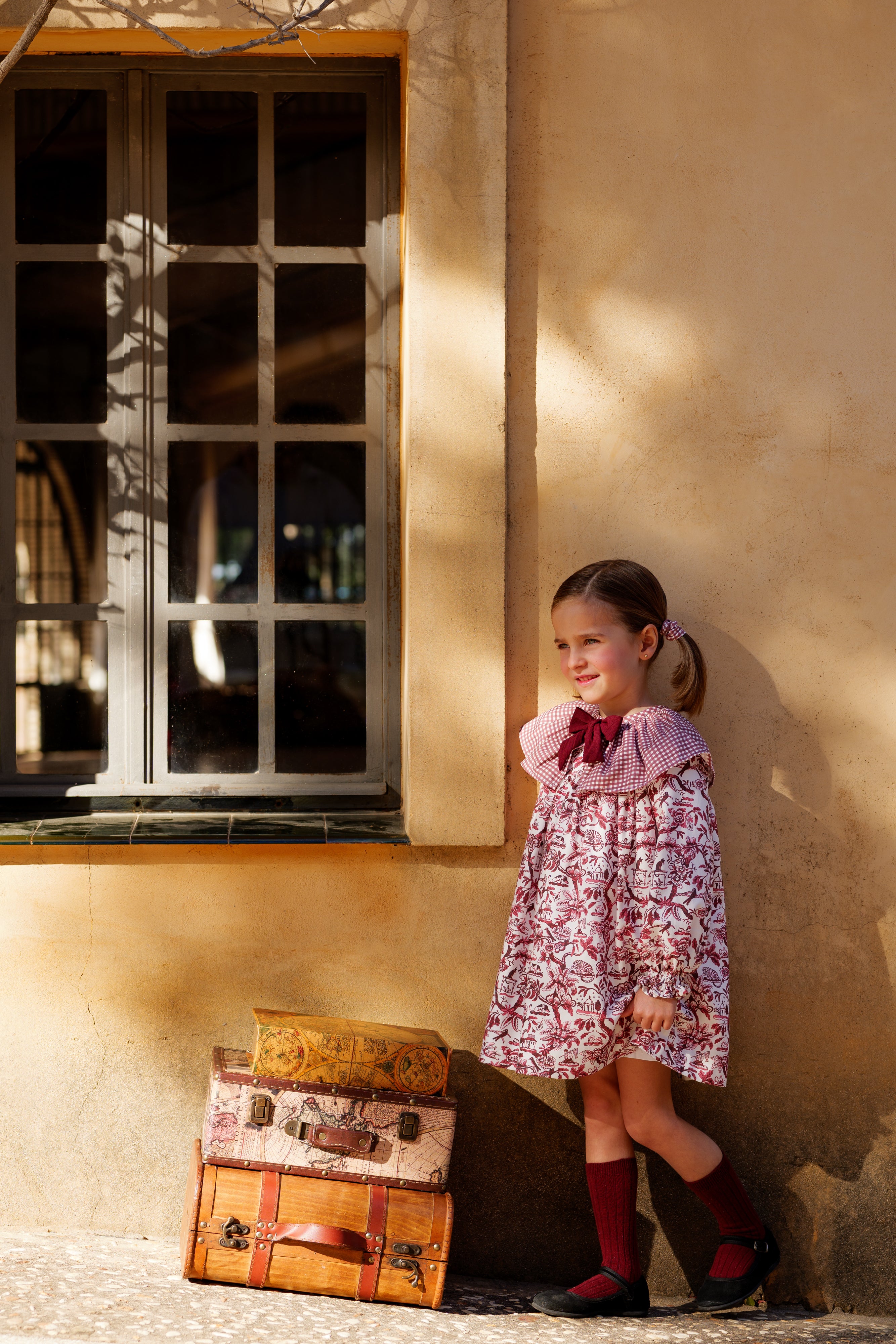 Vestido floral burdeos manga larga para niña con lazo, foto lateral en exterior Charanga