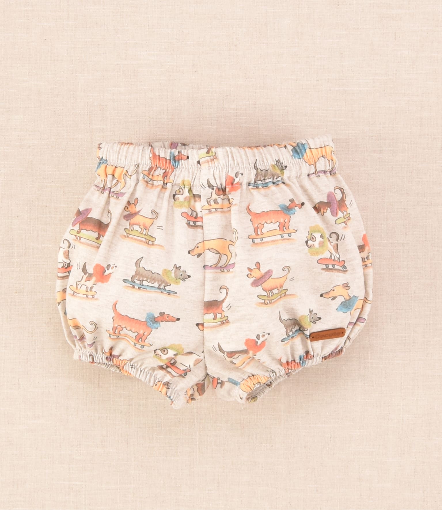 Ranita de bebé unisex con estampado de perritos sobre monopatines Cocote x Charanga