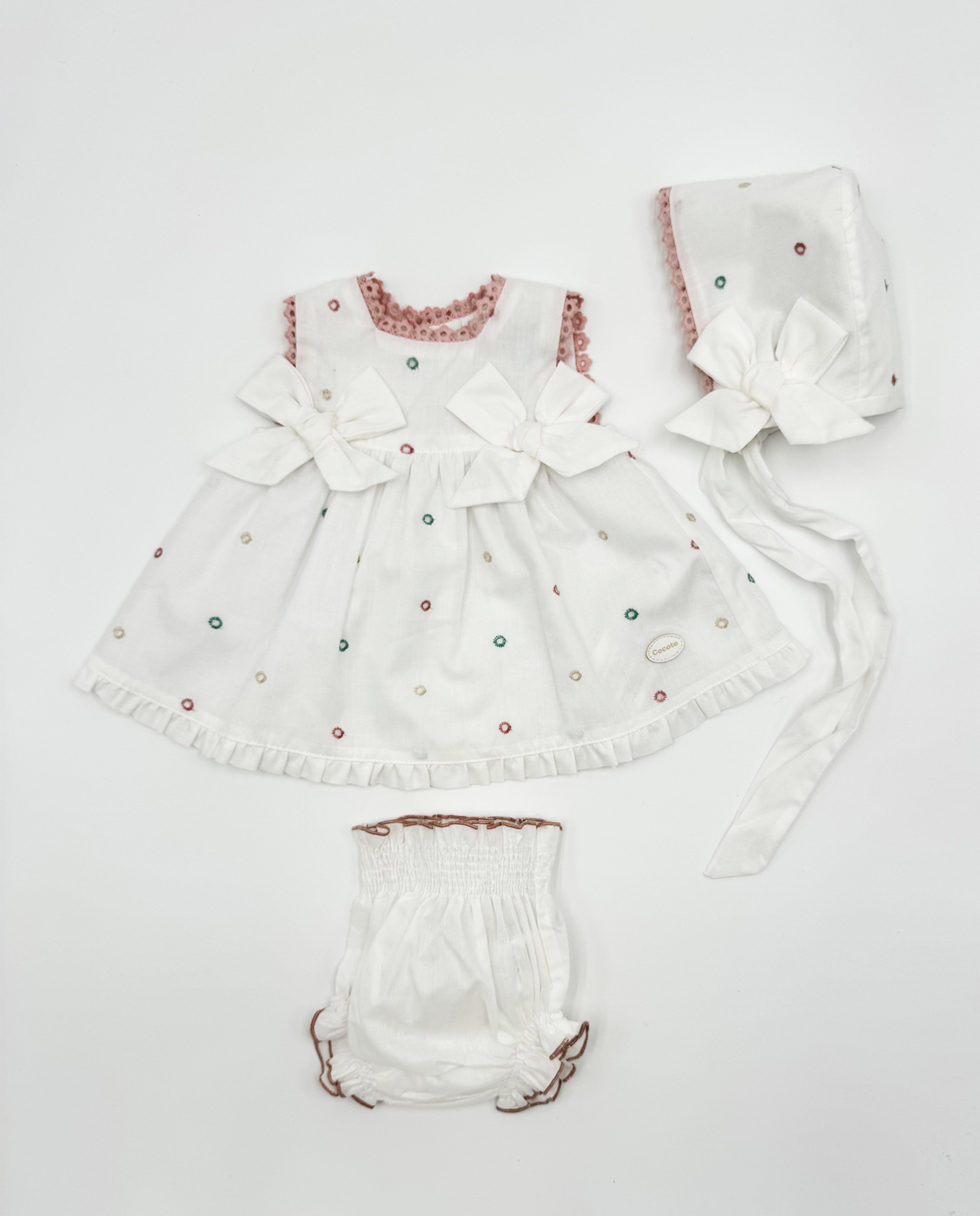 Conjunto vestido, braguita y capota perforado rosa lazos bebé | Cocote by Charanga