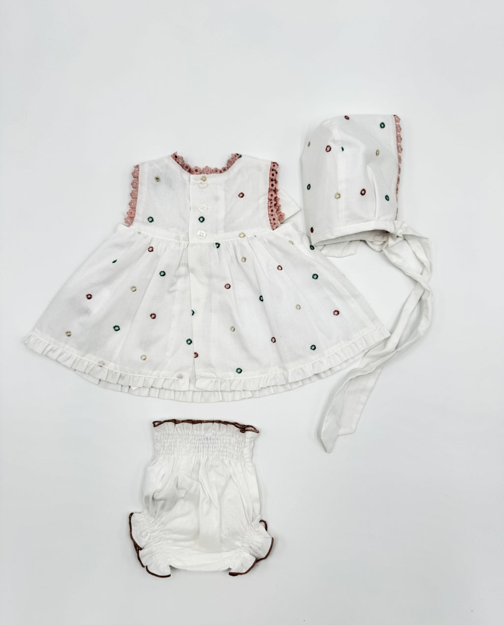 Conjunto vestido, braguita y capota perforado rosa lazos bebé | Cocote by Charanga
