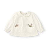 Baby shirt in ecru color with flower details