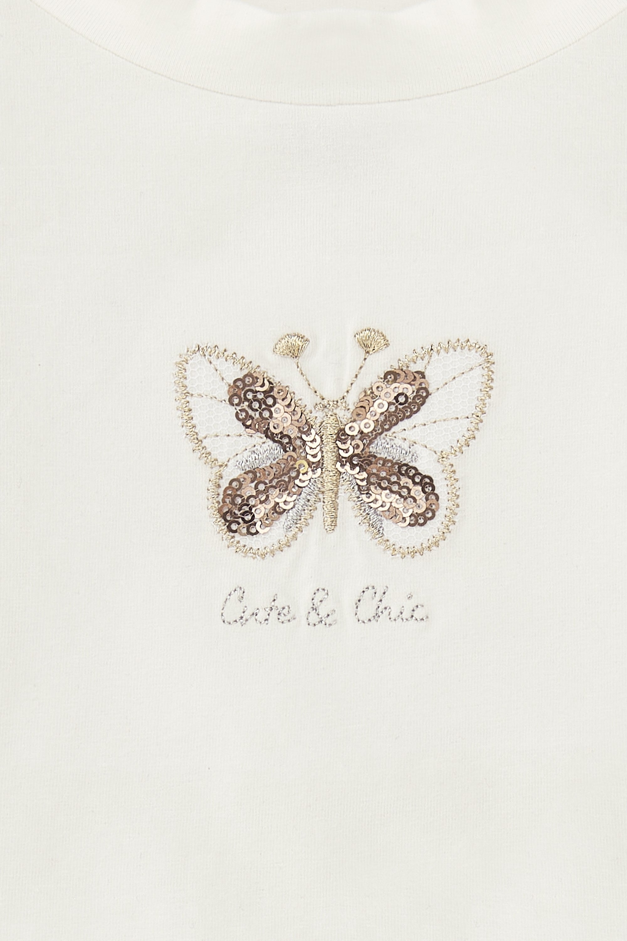Camiseta de niña en color crudo con detalle mariposa Charanga